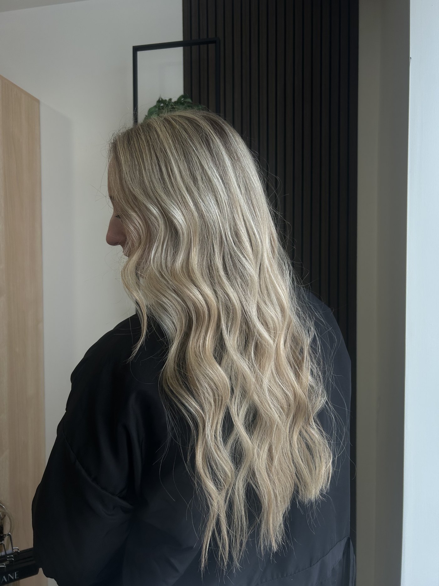 Long blonde wavy hair extension result at Fringe Beauty Studio